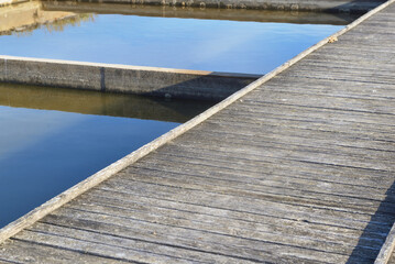 wooden walways crossing old seawater ponds  for oyster farming