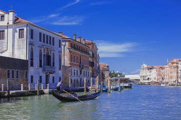 facades facing blue clean waters of busy grand canal of Venice