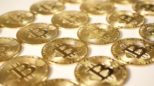 Golden bitcoins, diagonal pattern of real coins.