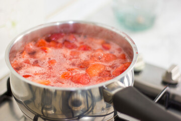 Making homemade red strawberry jam