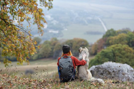 woman hiker in mountains with dog friendship nature landscape