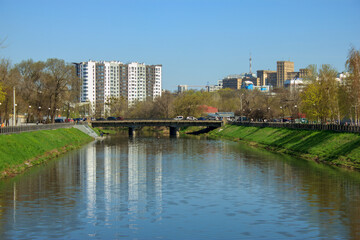 landscape with water canal and distant houses behind the bridge in kharkiv, Ukraine