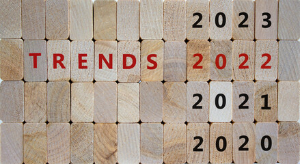 Business concept of 2022 trends. Wooden cubes with words 'TRENDS 2022' and numbers 2020, 2021, 2023. Beautiful wooden background, copy space. Business, 2022 trends concept.