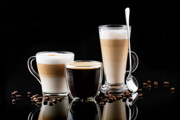 horizontal banner with different types of coffee in glasses on a black mirror background, cappuccino, americano, latte macchiato, coffee beans