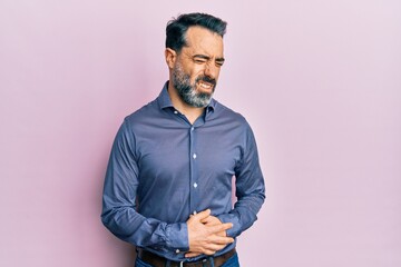 Fototapeta na wymiar Middle age man with beard and grey hair wearing business clothes with hand on stomach because nausea, painful disease feeling unwell. ache concept.