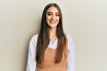 Obraz premium Beautiful brunette young woman wearing casual clothes with a happy and cool smile on face. lucky person.