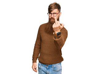 Young irish redhead man wearing casual clothes and glasses showing middle finger, impolite and rude...