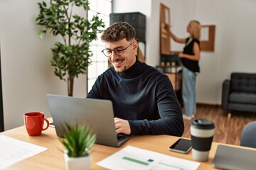 Two business workers smiling happy working at the office.