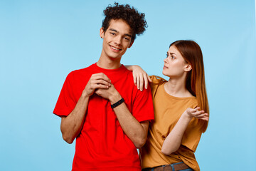 cheerful young couple in colorful t-shirts youth style cropped view
