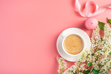 Floral background with cappuccino cup and candles on pink background.