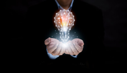 business hand holding illuminated light bulb, idea, innovation and inspiration concept.concept of creativity with bulbs that shine glitter, creativity with bulbs that shine glitter.Inspiration of idea