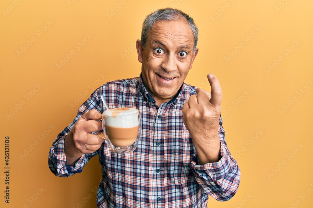 Sticker handsome senior man with grey hair drinking a cup coffee beckoning come here gesture with hand invit