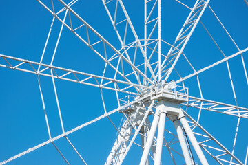 Fragment of ferris wheel on sunny day