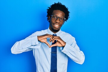 Young african american man wearing business clothes smiling in love doing heart symbol shape with hands. romantic concept.