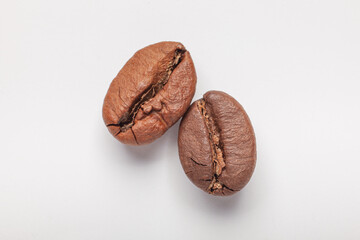 two coffee beans isolated on white background, macro photography