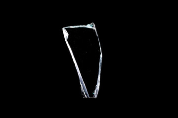 glass fragments in isolation on a black background. damaged window. damaged object