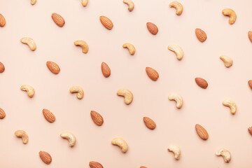 different nuts, almond, cashew on brown background flat lay pattern