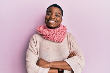 Young african american woman wearing winter scarf happy face smiling with crossed arms looking at...