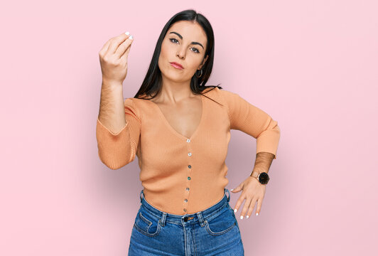 Young hispanic woman wearing casual clothes doing italian gesture with hand and fingers confident expression