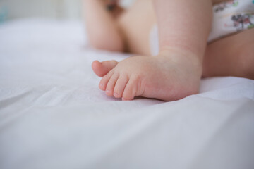 close-up of a toddler's bare feet on a blanket with room for text