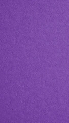 The surface of violet cardboard. Paper texture with cellulose fibers. Dark natural mobile phone wallpaper. Bright purple vertical background. Saturated color. Top-down. Macro