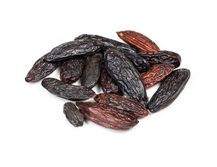 pile of dried tonka beans closeup on white