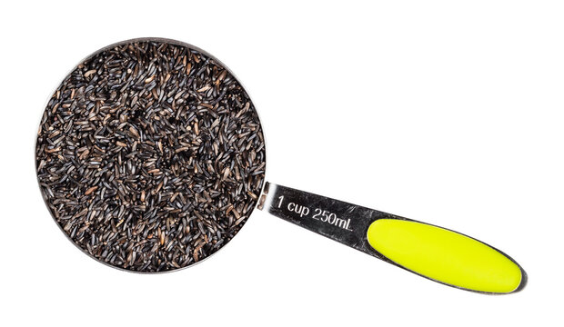 top view of niger seeds in measuring cup cutout