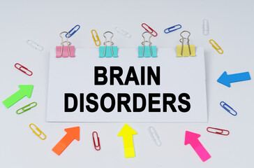On the table there are paper clips and directional arrows, a sign that says - Brain Disorders