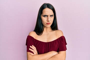 Fototapeta premium Young hispanic woman wearing casual clothes skeptic and nervous, disapproving expression on face with crossed arms. negative person.