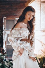Portrait of beautiful teenage girl with tropical plants. Natural female beauty