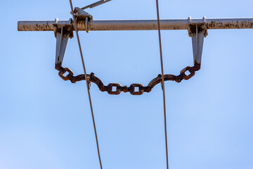 Fototapeta premium Trolleybus wires against the blue sky.