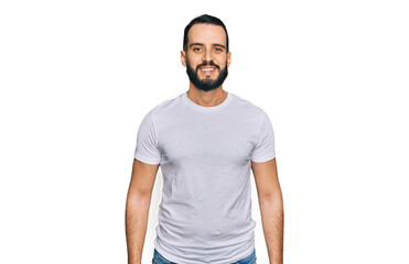 Young man with beard wearing casual white t shirt with a happy and cool smile on face. lucky person.
