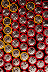 Lots of aa batteries, close-up. The batteries are put together.