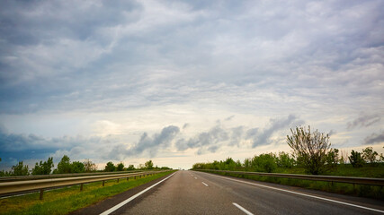 The highway traffic in sunset before the thunderstorm