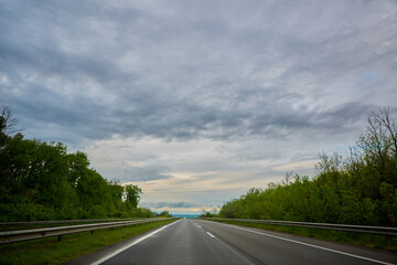 The highway traffic in sunset before the thunderstorm
