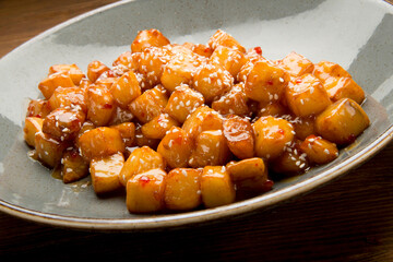 Butter fried potatoes with sweet chili and roasted sesame.