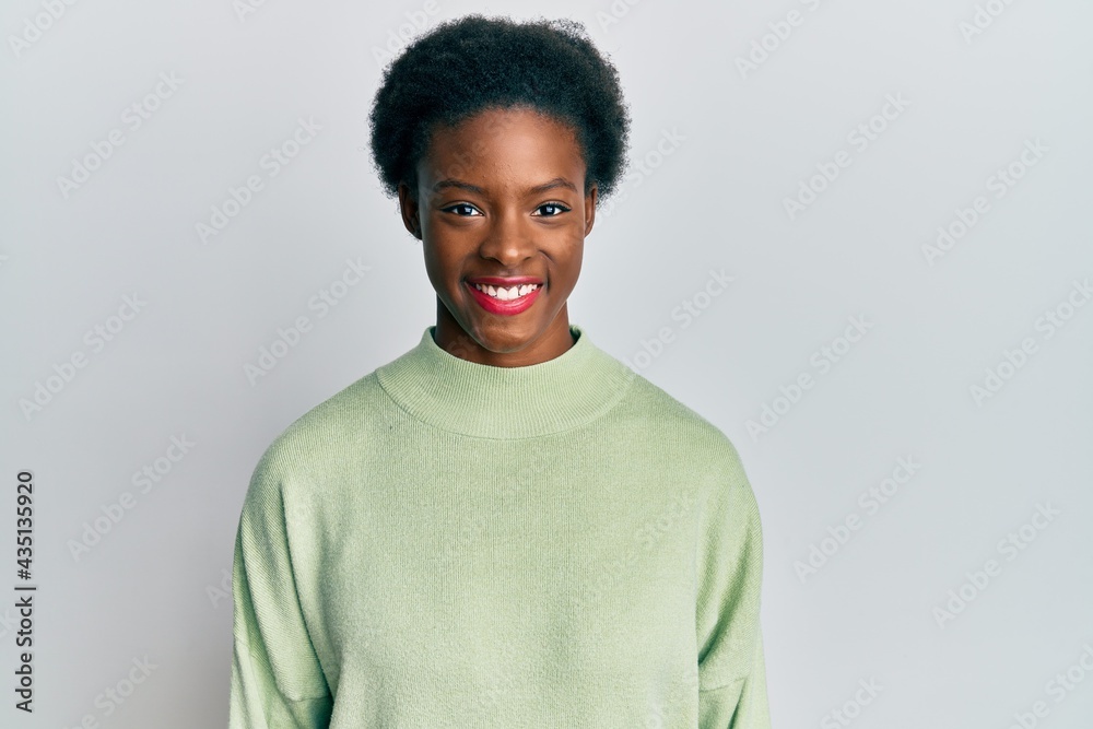 Sticker Young african american girl wearing casual clothes with a happy and cool smile on face. lucky person.