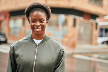 Young african american girl smiling happy standing at the city.