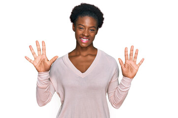 Young african american girl wearing casual clothes showing and pointing up with fingers number ten while smiling confident and happy.