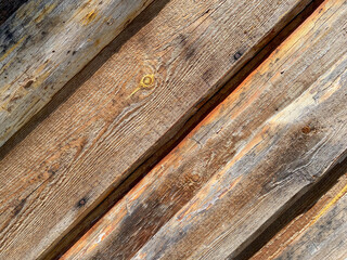 Brown wood texture of natural wood made from diagonal planks with knots. The background