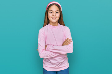 Beautiful brunette little girl wearing casual turtleneck sweater happy face smiling with crossed arms looking at the camera. positive person.