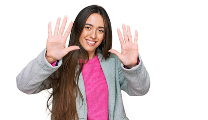 Young hispanic girl wearing business clothes showing and pointing up with fingers number ten while smiling confident and happy.