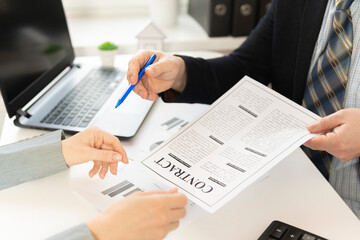 two businessmans at the table sign a contract. close-up. high quality