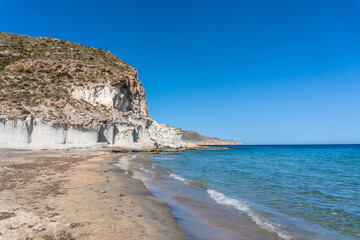 Fototapeta na wymiar The beautiful Enmedio beach in Cabo de Gata on a beautiful summer day, Almería. Mediterranean sea, spain 