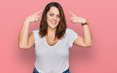 Young plus size woman wearing casual white t shirt smiling pointing to head with both hands finger, great idea or thought, good memory