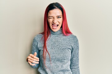 Young caucasian woman wearing casual clothes winking looking at the camera with sexy expression,...
