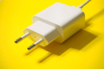 Charging 220 volts for a phone with a usb connector on a yellow background - 435138942
