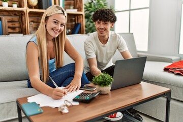 Young couple controlling family economy at home.