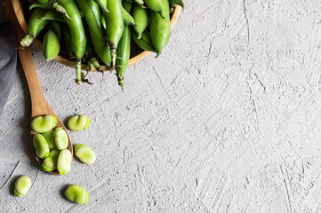Fresh broad beans with pod on rustic background, healthy food - obrazy, fototapety, plakaty