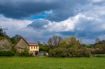 Landscape on the outskirts of Bamberg, Germany with spring meadow and impressive cloud play in the background